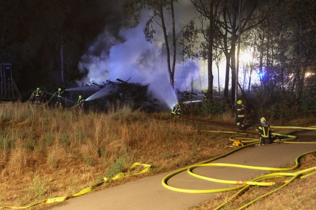 Waldbrand verhindert: Gr��erer Einsatz bei Brand eines gro�en Haufens gelagerter Holzst�mme in Traun